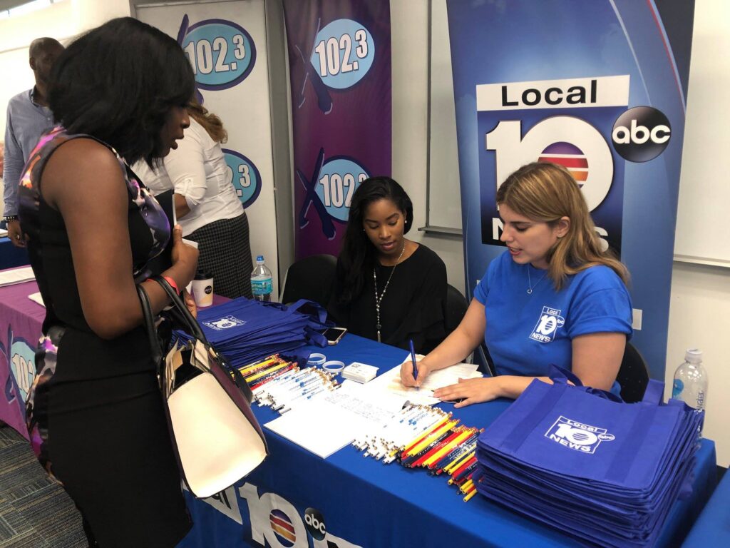 A woman is signing up for an event.