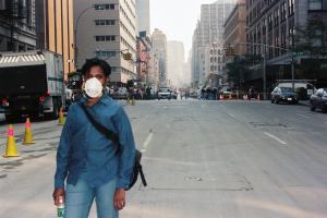 A person wearing a mask while walking down the street.